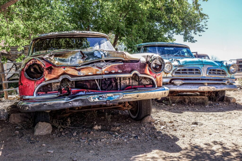 Old rusted scrap cars ready for evaluation and removal by junk car buyers.