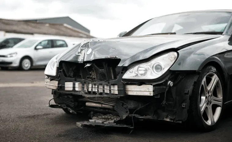 Fast scrap car removal near me service in your Area for a damaged black sedan.